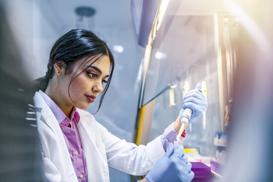 scientist conducting experiment in fume cupboard