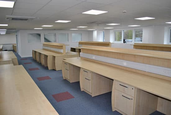 Office Furniture, desks and drawers with a blue & red carpet