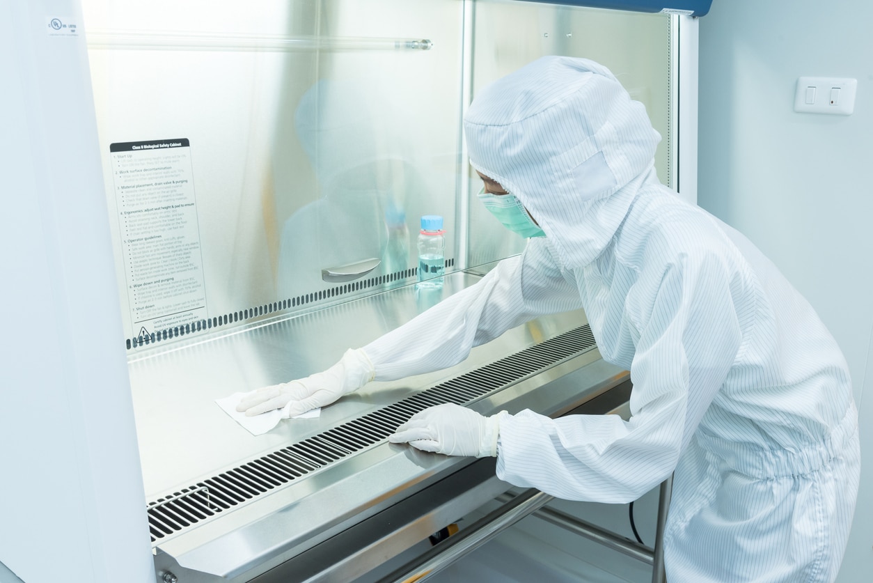 lab worker scrubbing down surfaces