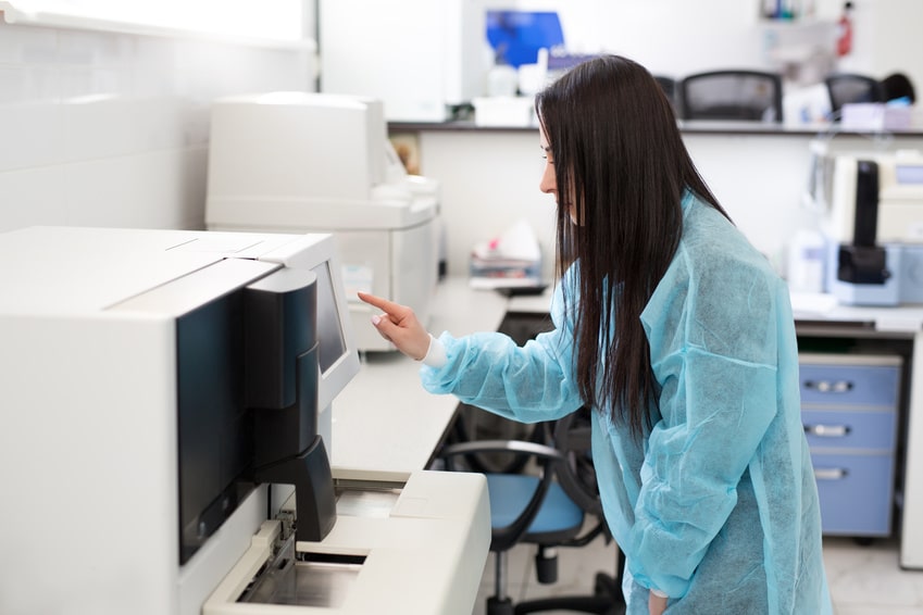 A female scientist using a lab oven