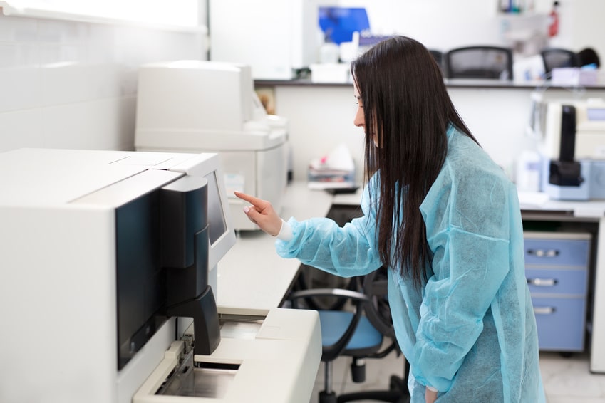 A female scientist using a lab oven 