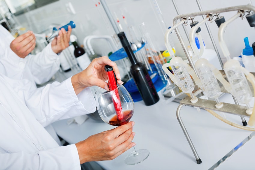 A scientist testing synthetic wine created in a laboratory