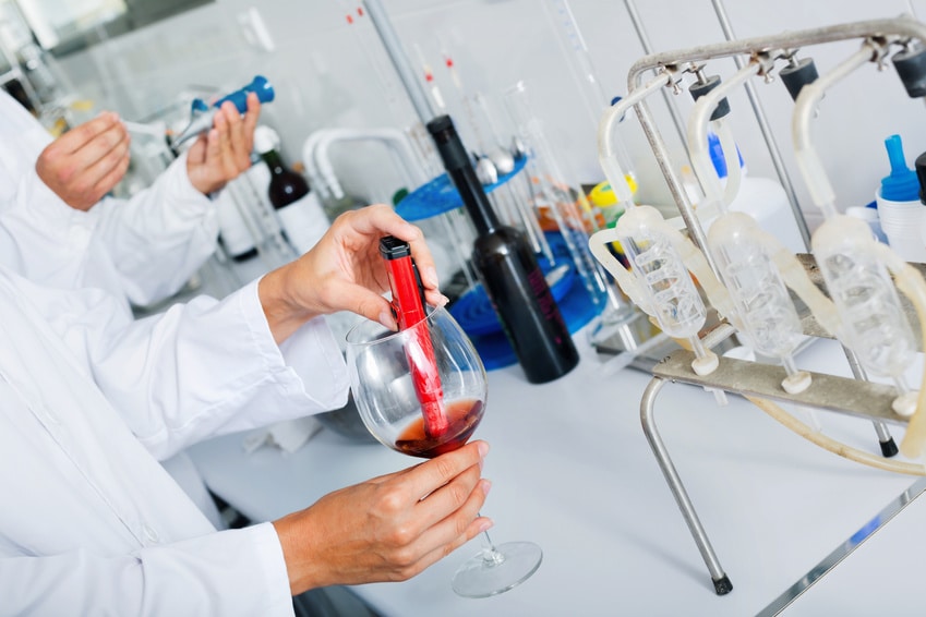 A scientist testing synthetic wine created in a laboratory 