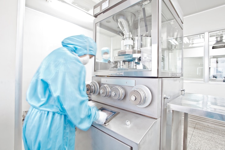 A scientist working with some technical machinery in a science lab