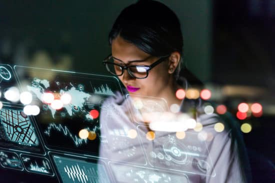 woman engineer looking at BIM on a screen of futuristic interface.