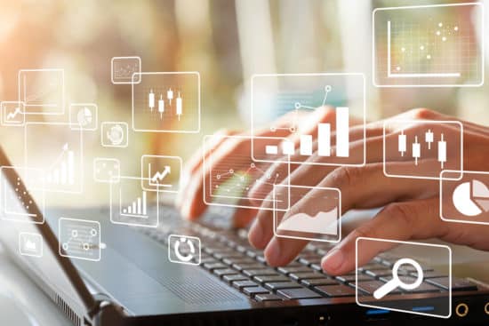 Business intelligence concept. Big data analytics, chart and graph icons and female hands typing on laptop.