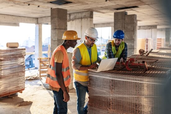 construction workers looking at plans