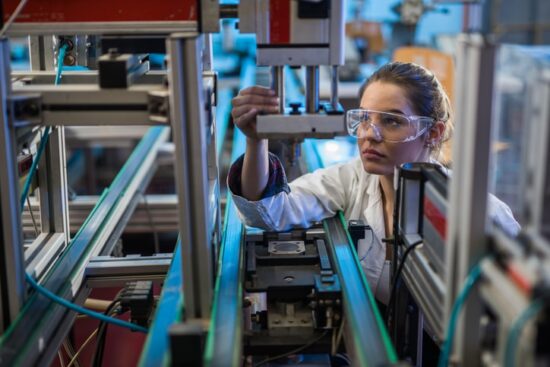 scientist examining machine part