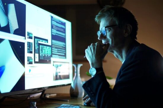 man smiling at his computer