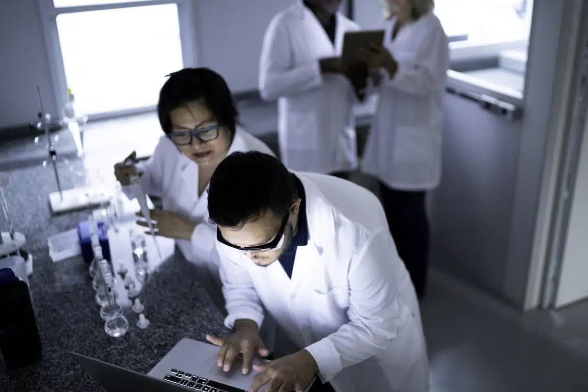 scientists analysing data on laptop