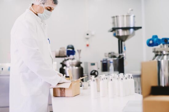 lab worker packing bottles of lotion