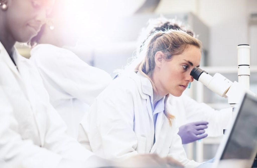 scientist using microscope laboratory