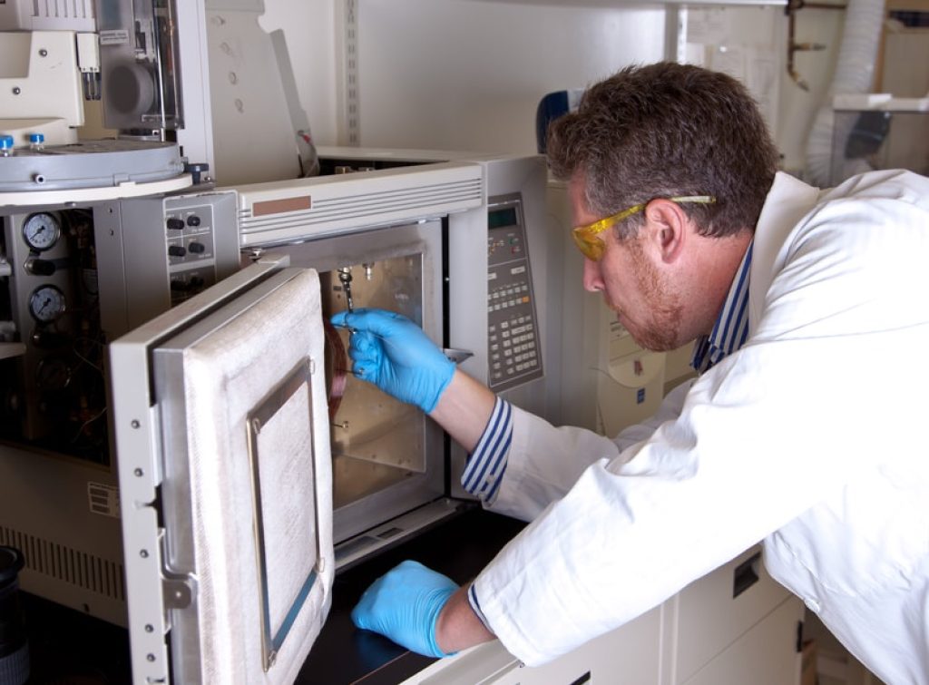 Scientist prepares chromatograph oven installing column