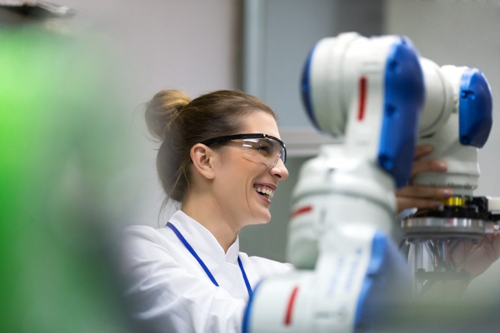 Female engineers working on robotic arm development