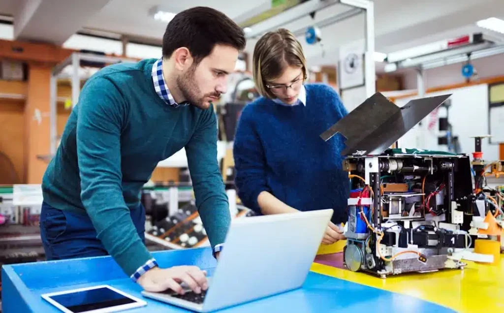 Young students of robotics working on project together